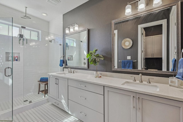 bathroom featuring vanity and a shower with shower door