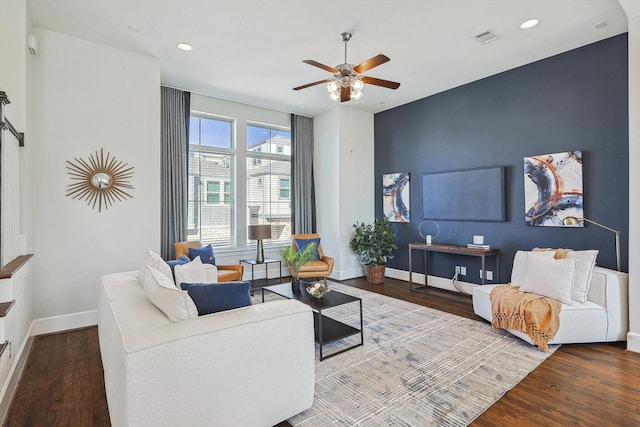 living room featuring hardwood / wood-style floors and ceiling fan