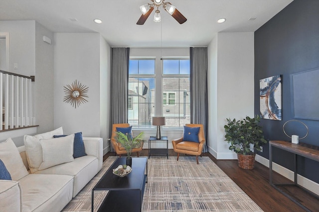 living room featuring dark hardwood / wood-style floors and ceiling fan