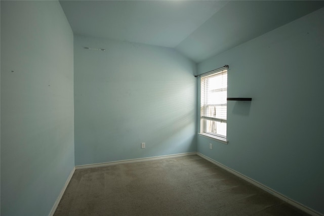 empty room with vaulted ceiling and carpet