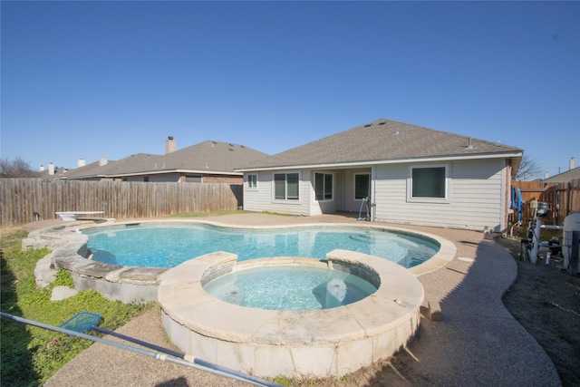 view of pool with an in ground hot tub and a diving board