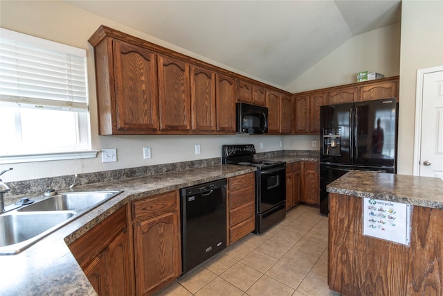 kitchen featuring lofted ceiling, sink, light tile patterned floors, and black appliances