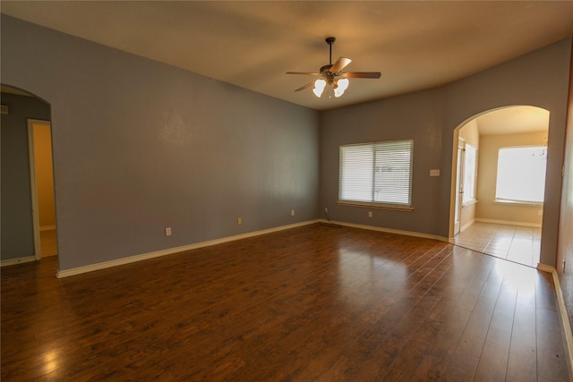 unfurnished room featuring dark hardwood / wood-style floors and ceiling fan