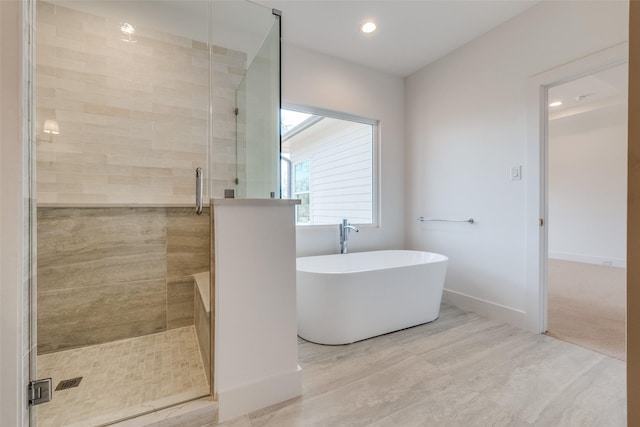 bathroom featuring hardwood / wood-style floors and shower with separate bathtub