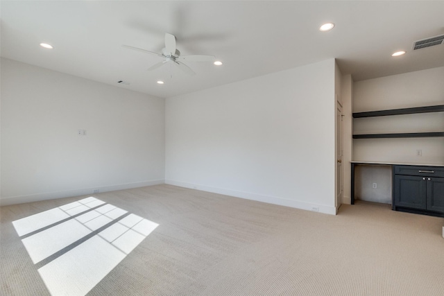 spare room with light carpet and ceiling fan