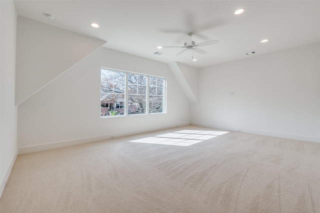 additional living space with light carpet and ceiling fan