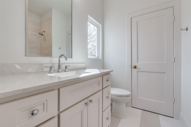 bathroom featuring vanity, a shower, tile patterned floors, and toilet