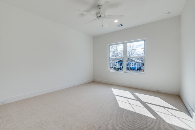 empty room featuring light carpet and ceiling fan