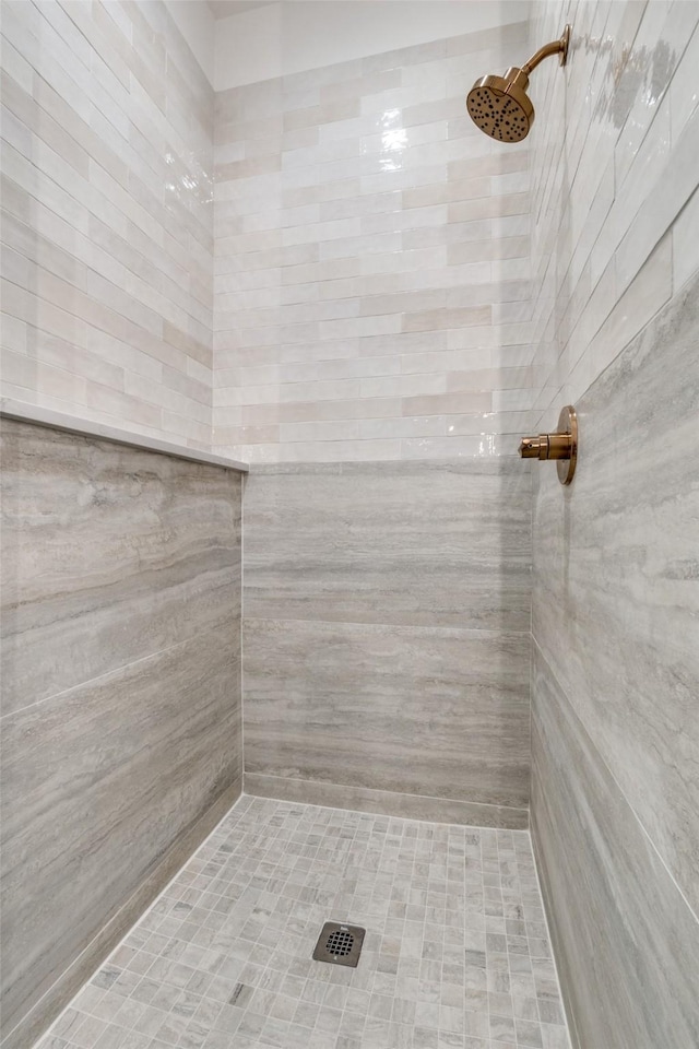 bathroom with tiled shower