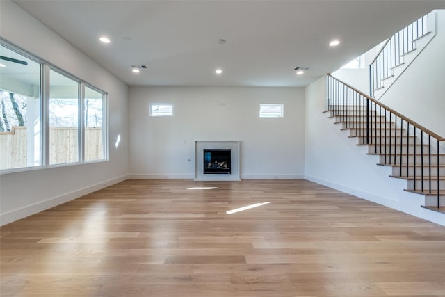 unfurnished living room with light hardwood / wood-style flooring