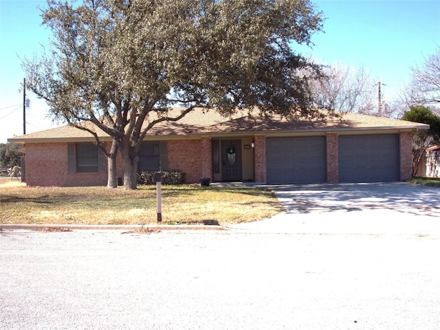 ranch-style house featuring a garage and a front yard