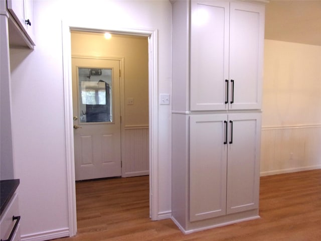 hall with light hardwood / wood-style floors