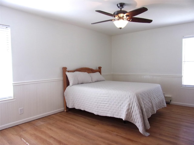 bedroom with ceiling fan and wood-type flooring