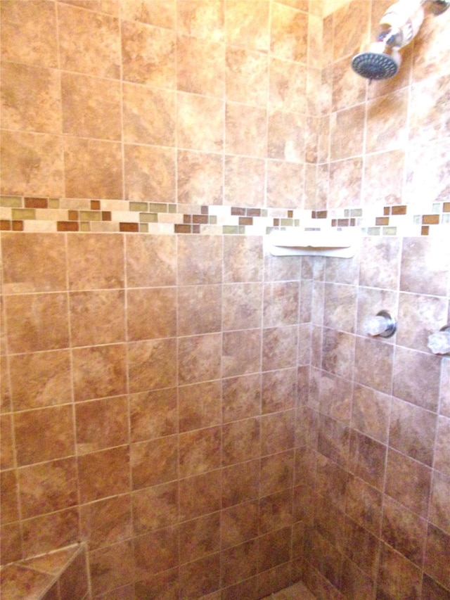 bathroom with a tile shower