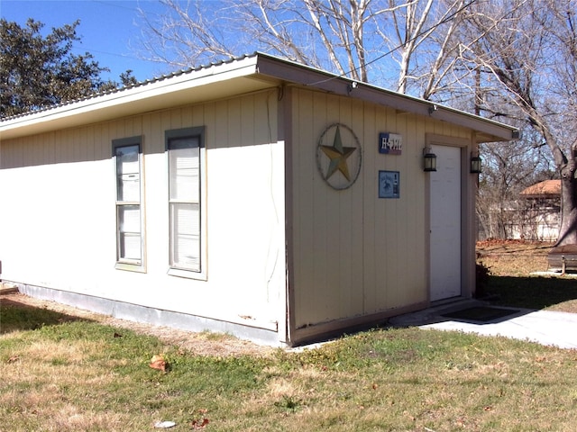 view of side of property with a lawn