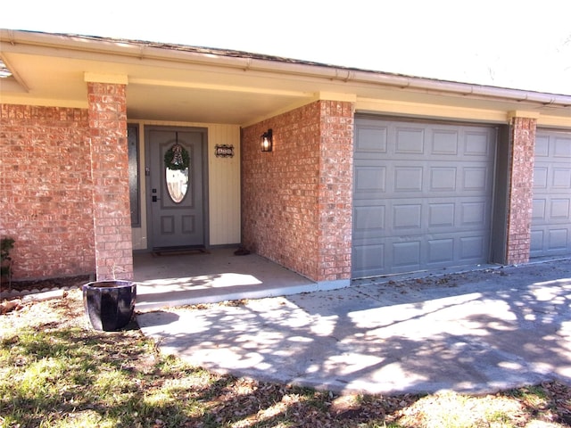 doorway to property with a garage