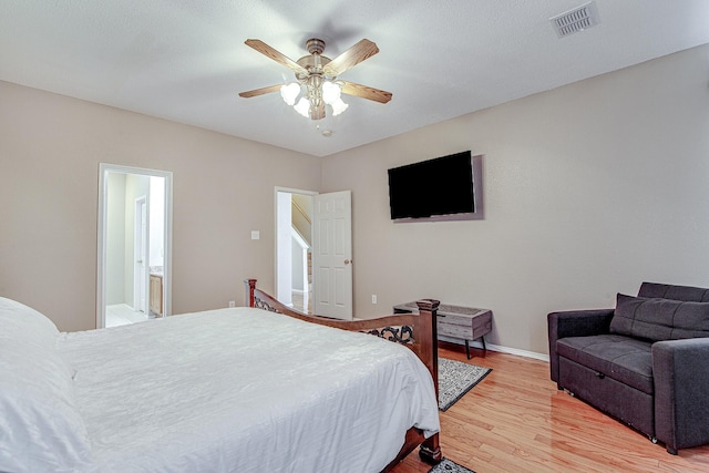 bedroom featuring light wood finished floors, visible vents, ceiling fan, and baseboards