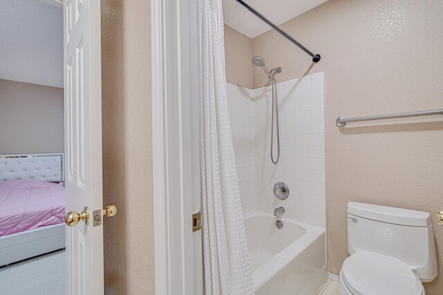 bathroom featuring ensuite bathroom, toilet, and shower / tub combo