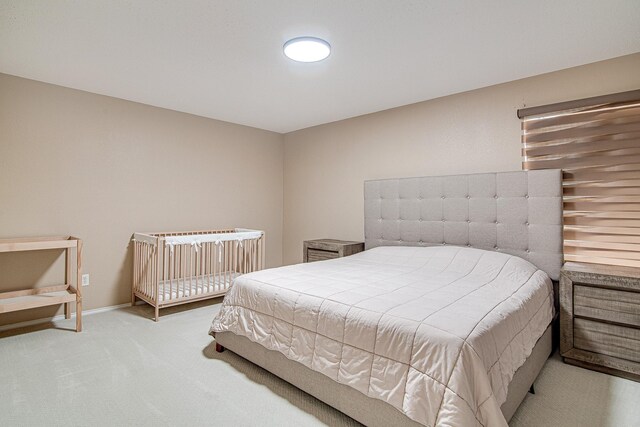 carpeted bedroom featuring baseboards