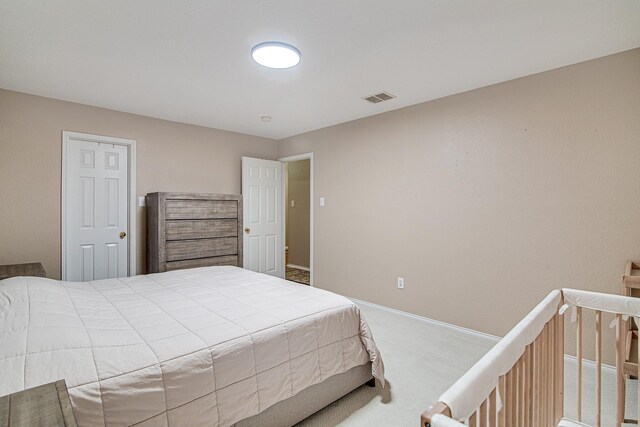 carpeted bedroom featuring visible vents and baseboards