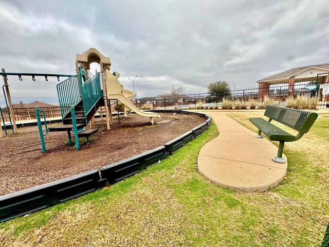 community jungle gym featuring fence