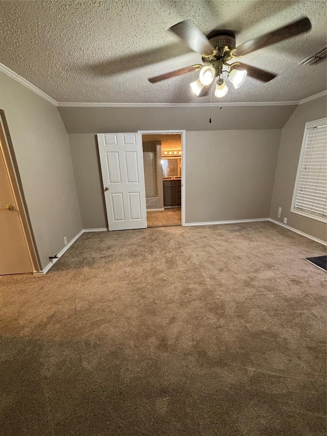 unfurnished bedroom with crown molding, carpet floors, ensuite bath, and a textured ceiling