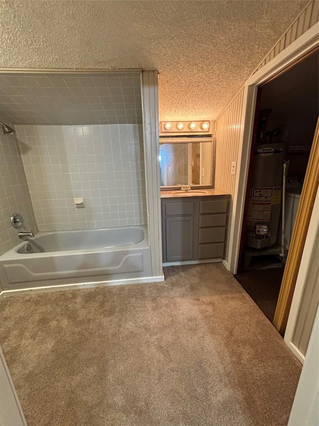 bathroom with vanity, tiled shower / bath combo, water heater, and a textured ceiling