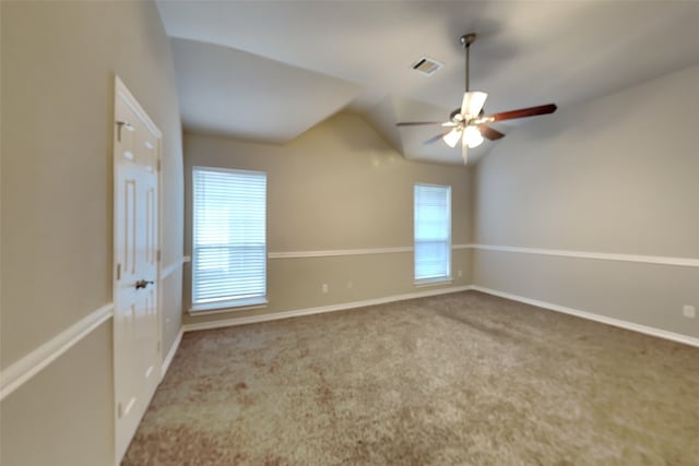 carpeted spare room featuring ceiling fan and vaulted ceiling