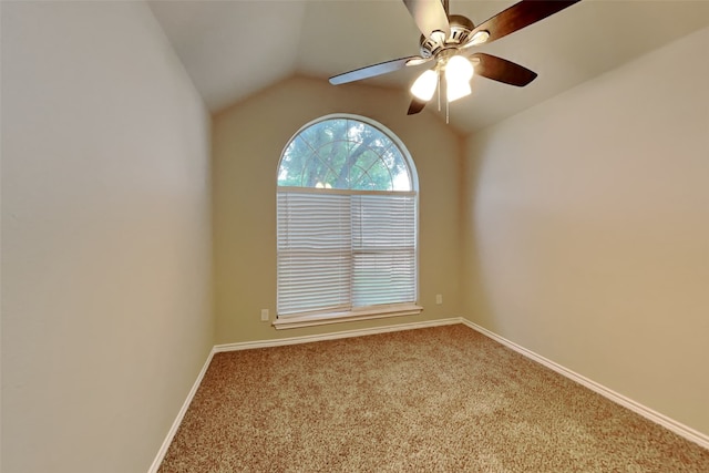 empty room featuring lofted ceiling, carpet, and ceiling fan