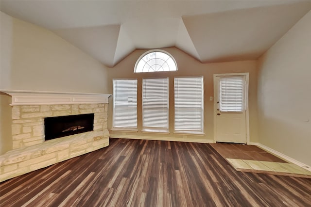 unfurnished living room with lofted ceiling, a fireplace, and dark wood-type flooring