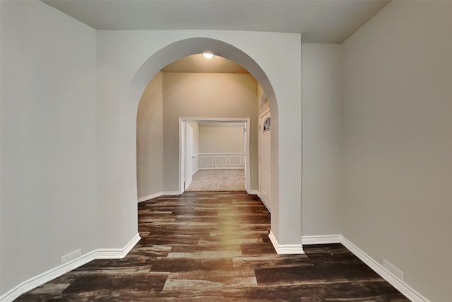 hallway with dark hardwood / wood-style flooring