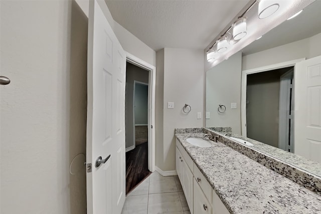 bathroom with vanity, tile patterned floors, and a textured ceiling