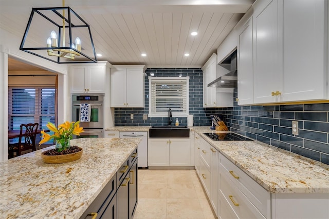 kitchen featuring decorative light fixtures, sink, and white cabinets