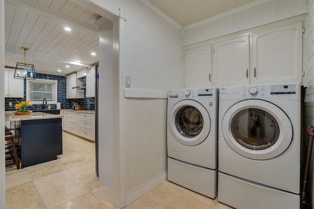 laundry area with ornamental molding and separate washer and dryer