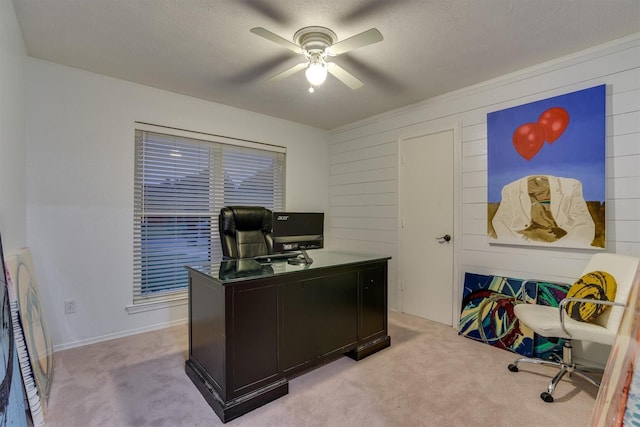 carpeted office with ceiling fan and a textured ceiling