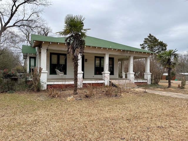 view of front of property with covered porch and a front lawn