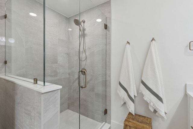 bathroom featuring a shower with shower door