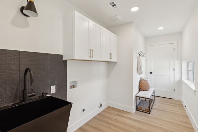 laundry room with sink, cabinets, electric dryer hookup, washer hookup, and light hardwood / wood-style floors