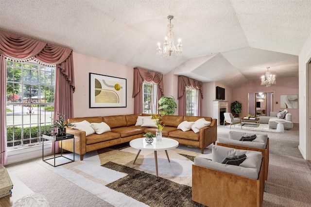 living room featuring an inviting chandelier, light colored carpet, lofted ceiling, and a wealth of natural light