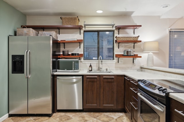 kitchen featuring sink, dark brown cabinets, and stainless steel appliances