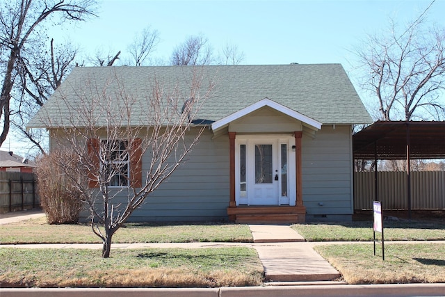231 N 5th Ave, Munday, TX 76371 - view of front of house with a carport and a front yard