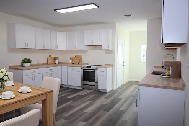 231 N 5th Ave, Munday, TX 76371 - kitchen with white cabinetry, electric range, dark hardwood / wood-style flooring, and wooden counters