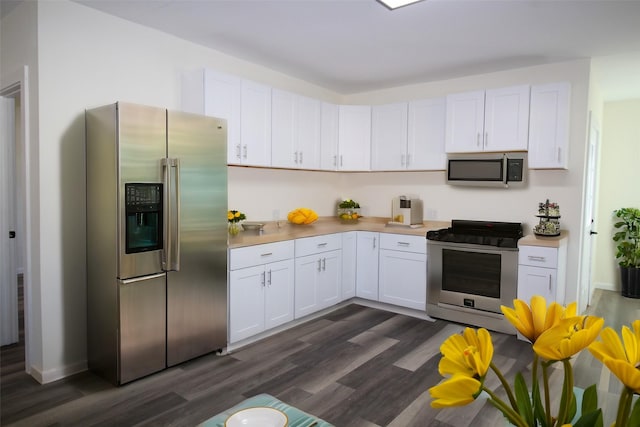 231 N 5th Ave, Munday, TX 76371 - kitchen featuring white cabinetry, stainless steel appliances, and dark wood-type flooring