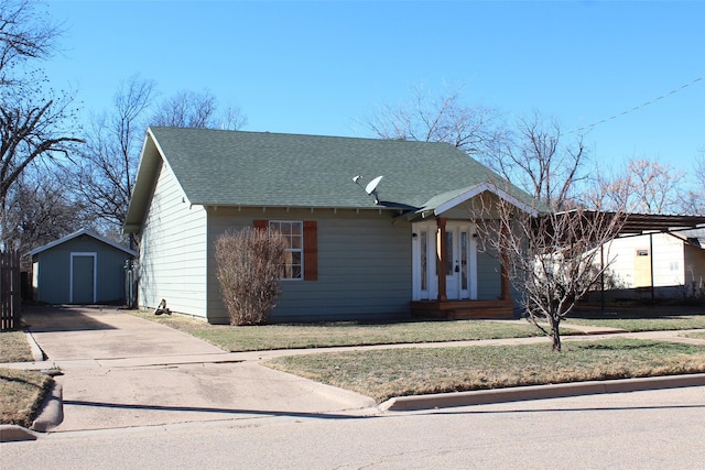 231 N 5th Ave, Munday, TX 76371 - view of front of property featuring a carport and a storage unit