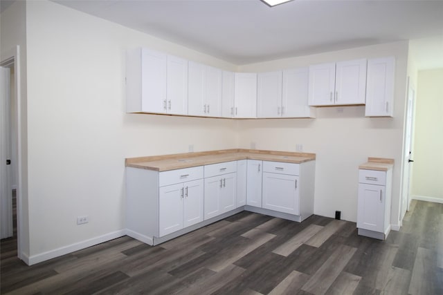231 N 5th Ave, Munday, TX 76371 - kitchen with white cabinetry, dark hardwood / wood-style flooring, and butcher block counters