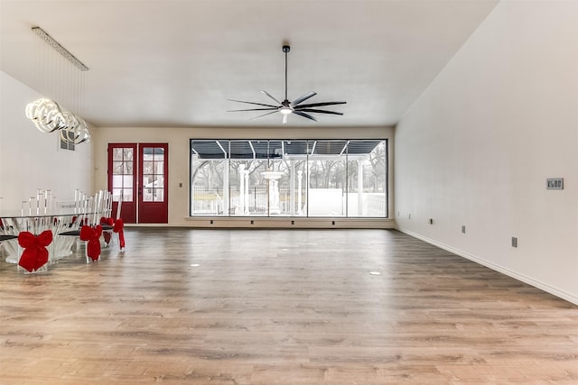 unfurnished living room featuring ceiling fan and light wood-type flooring