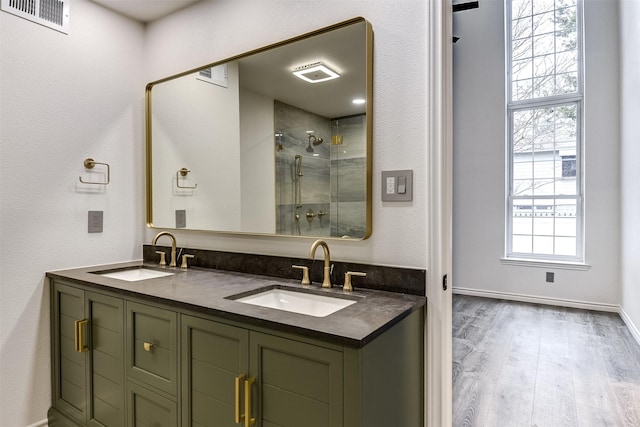 bathroom with a shower with door, wood-type flooring, and vanity