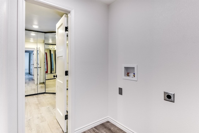 laundry area featuring hookup for a washing machine, electric dryer hookup, and light hardwood / wood-style flooring