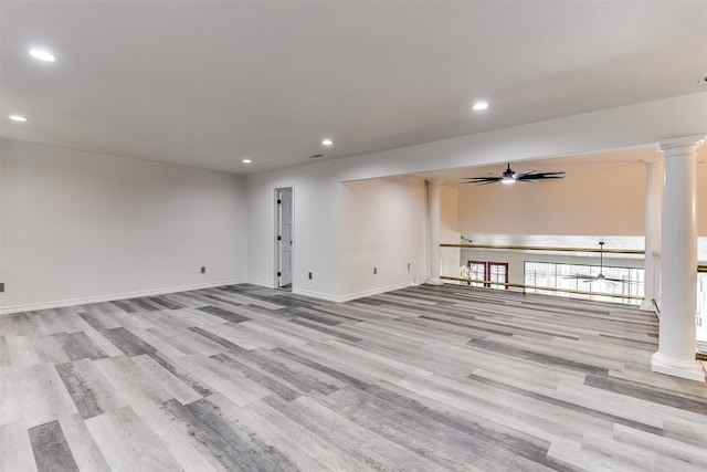 interior space featuring ornate columns, ceiling fan, and light hardwood / wood-style floors