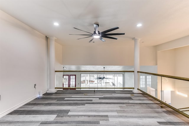 interior space with hardwood / wood-style floors, decorative columns, and ceiling fan